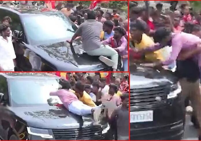 There was a stir after volunteers climbed on Vijay's car!